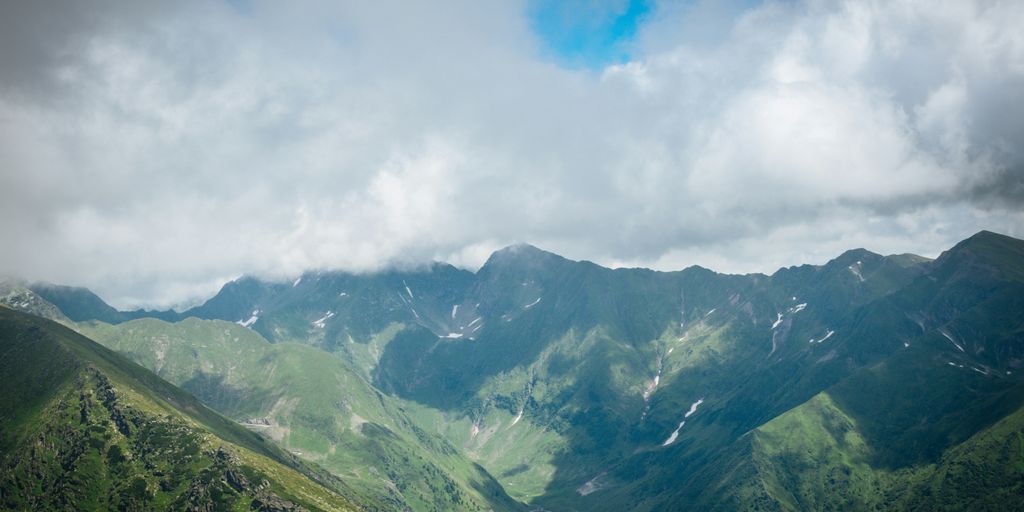 green mountains under white clouds during daytime