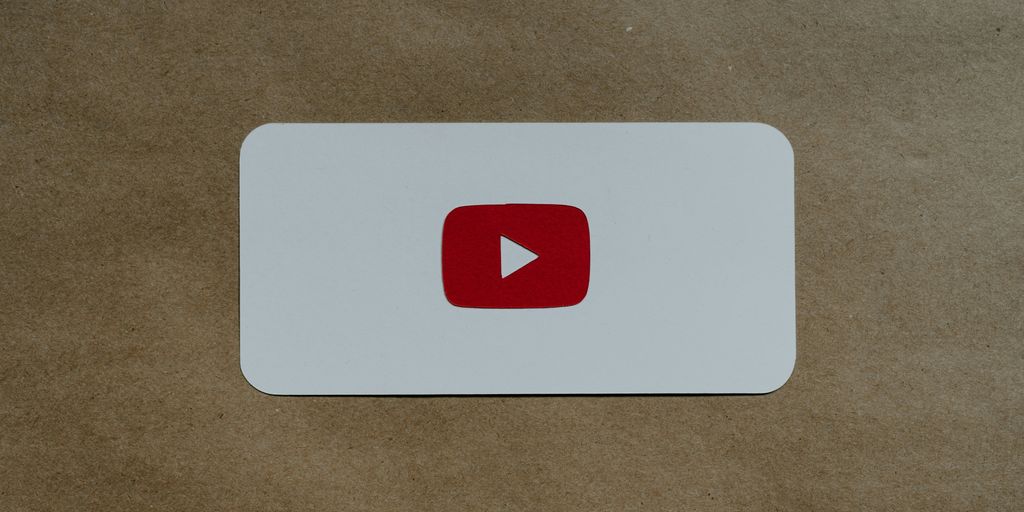 a white card with a red youtube logo on it